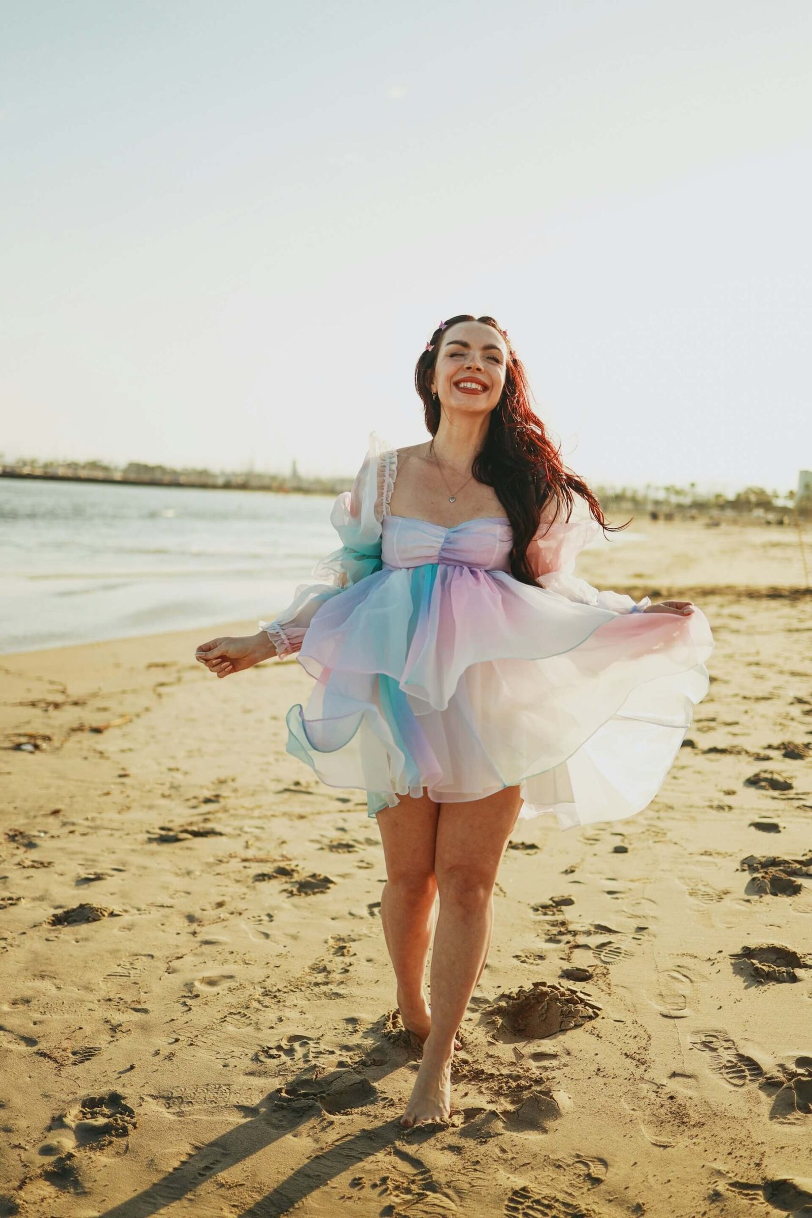 a woman on the beach in a floaty dress